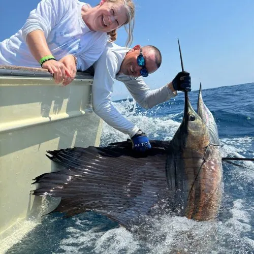 Two people catching a fish