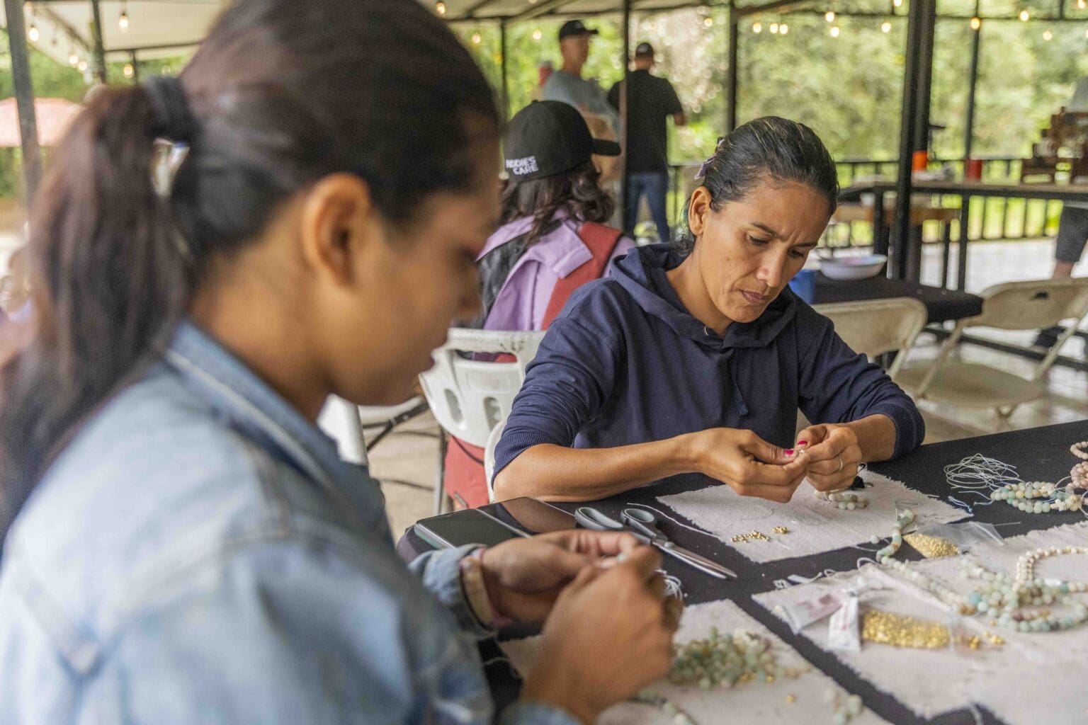 Mothers in the Beloved program making beaded jewelry