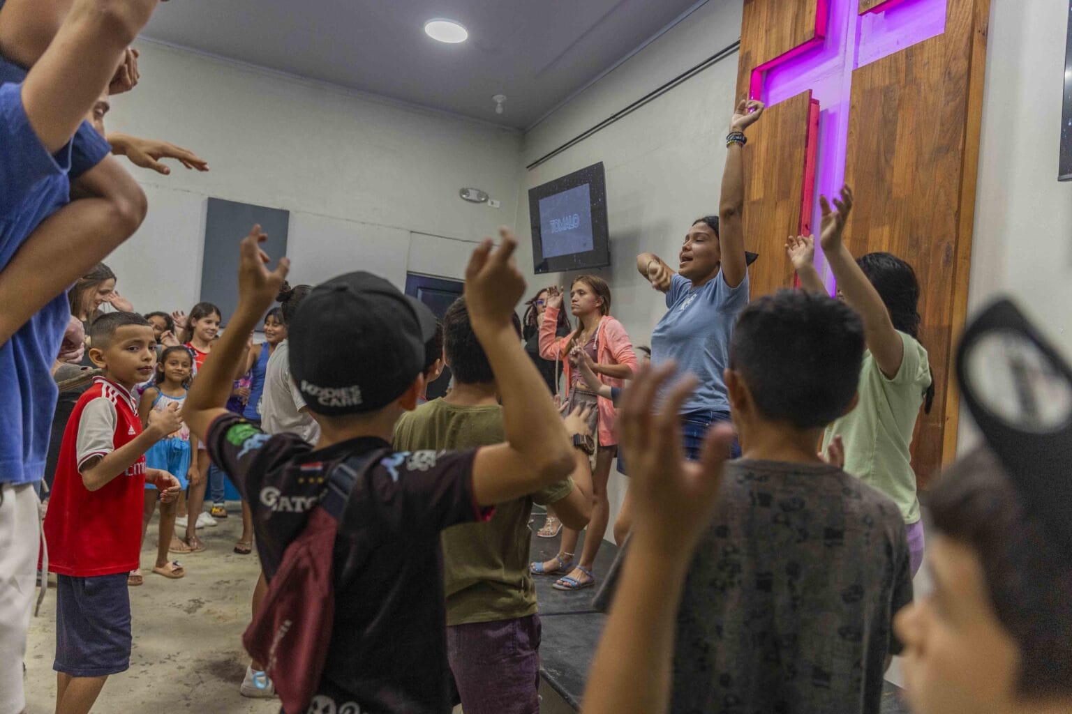 Kids and staff worshipping together at Crash Kids